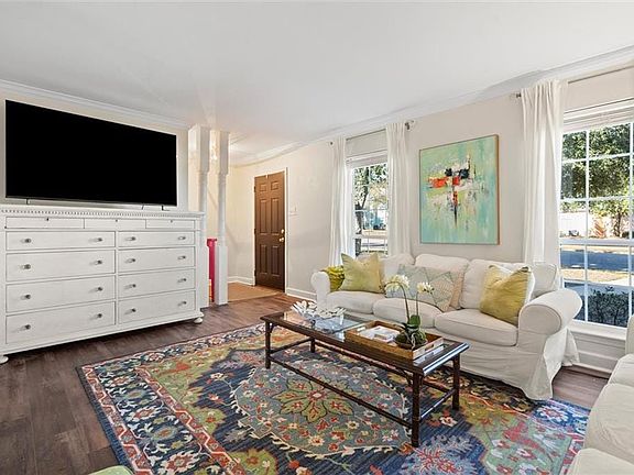 Living room featuring dark hardwood / wood-style flooring and crown molding