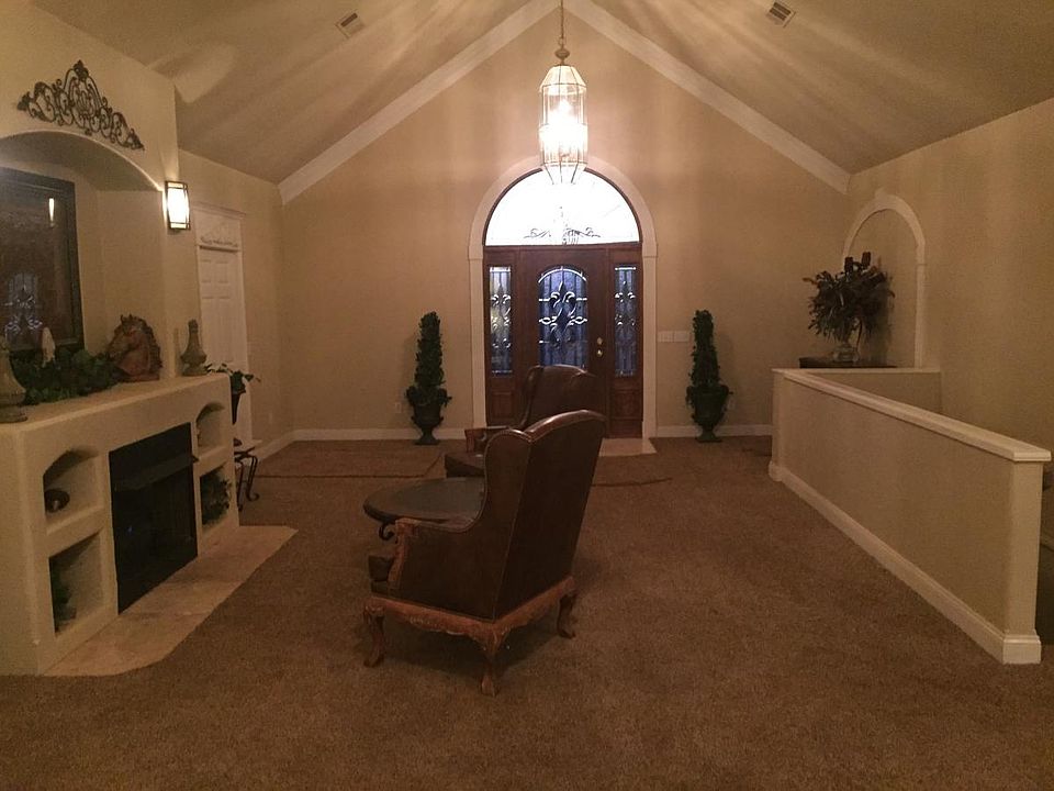 Great room with fireplace and front door entrance