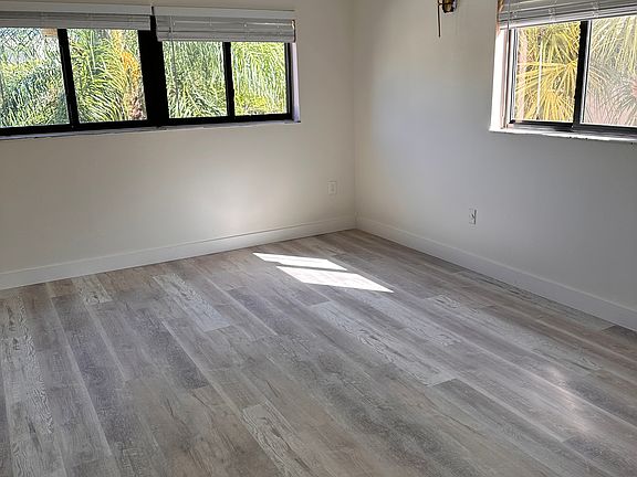 Master bedroom, completely remodeled, new floors, lighting fixtures, window treatments, impact windows, lots of light corner unit.