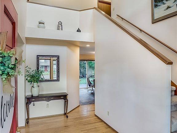 Entrance welcomes you with a soaring ceiling and hardwood floors.