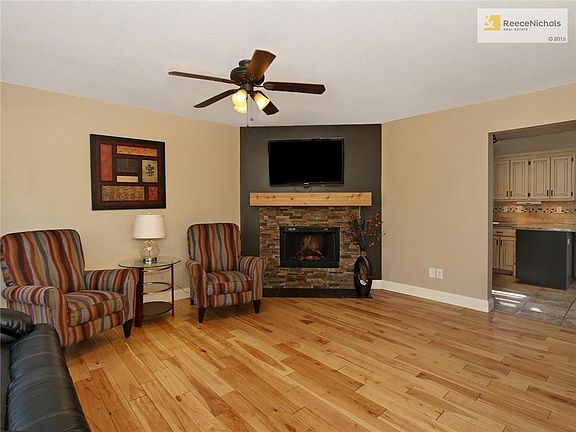 Large family room with beautiful wood floors and gas fireplace.