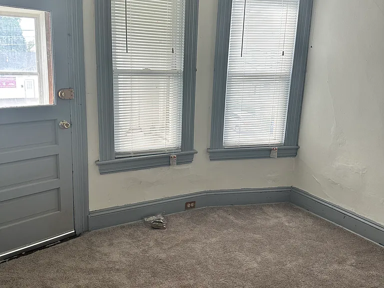 Small bedroom #3 with carpet and front balcony entry