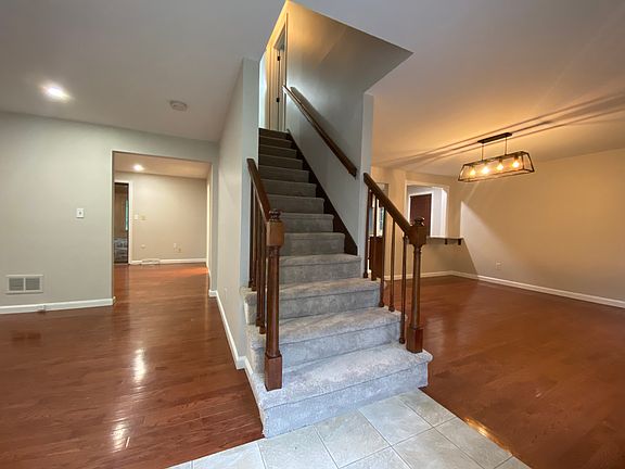 Front entry and staircase between living room and dining room