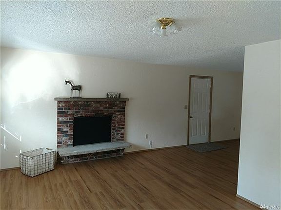 Wonderful Brick Fireplace...you can see it from the dining and kitchen, also!