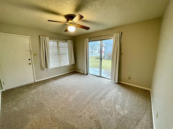 Living room (approximately 12' X 14') - Fresh paint and flooring throughout.