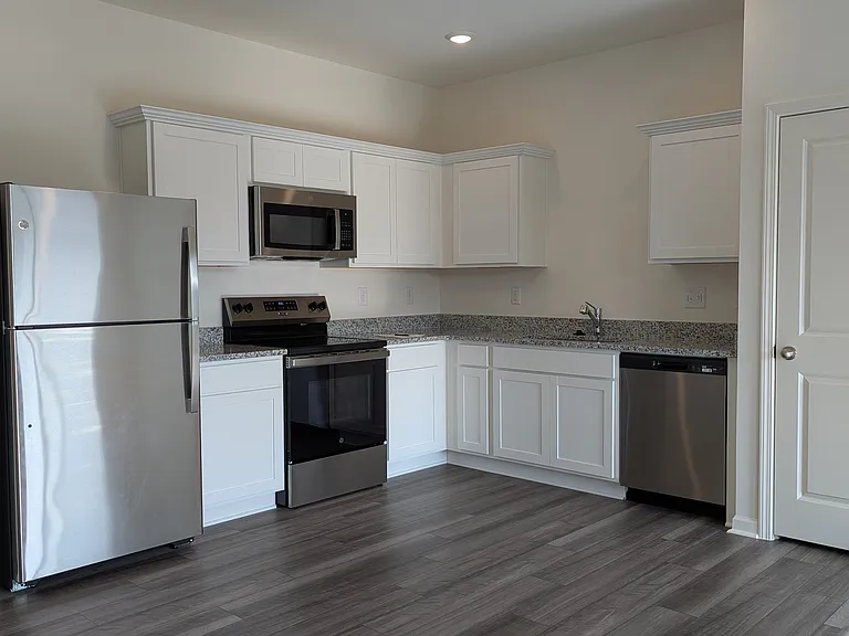Open kitchen with all new stainless steel appliances and granite countertops
