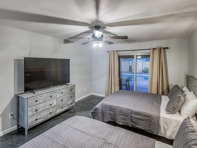 Full wall media space and sliding door access to the private pool area.
