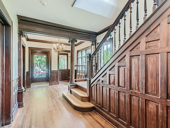 Building entry with grand staircase and oak panels.