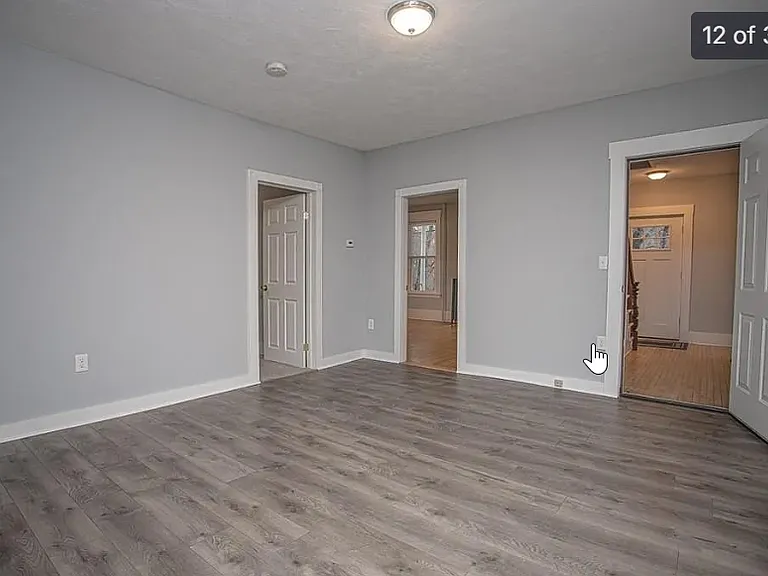 Livingroom to front entrance door and entrances to 3rd bedroom and the master bedroom.