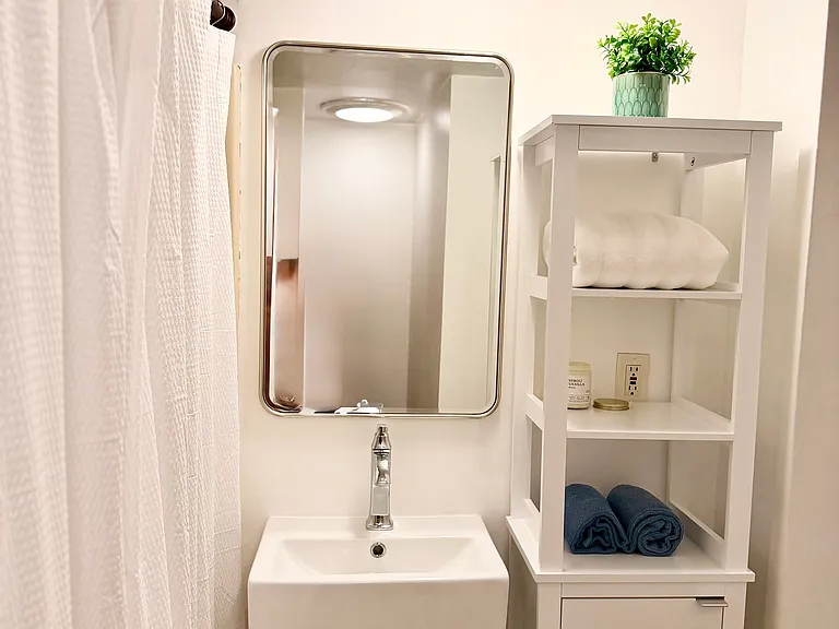 New vanity, mirror, sink and storage.