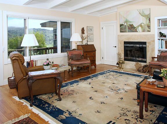 Living room with vaulted ceilngs,hardwood floors, marble surround fireplace