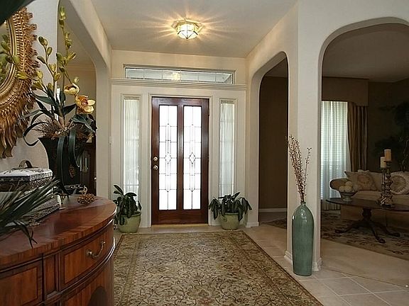 Foyer features crown molding, tile floor and open to both formals.