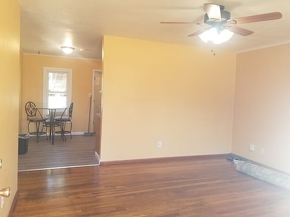Living room view from entrance. Dinette and kitchen area with new laminate flooring.