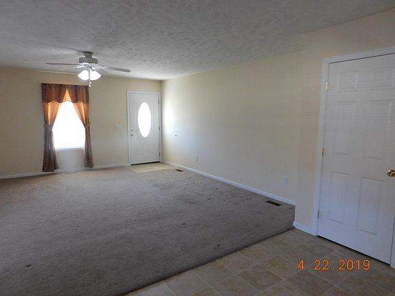 LOOKING FROM KITCHEN, LIVING ROOM, CLOSED DOOR IS COAT CLOSET