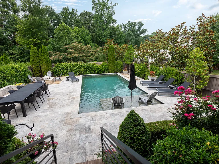 Backyard oasis includes lounge chairs for tanning as well as a great table for dining with guests.