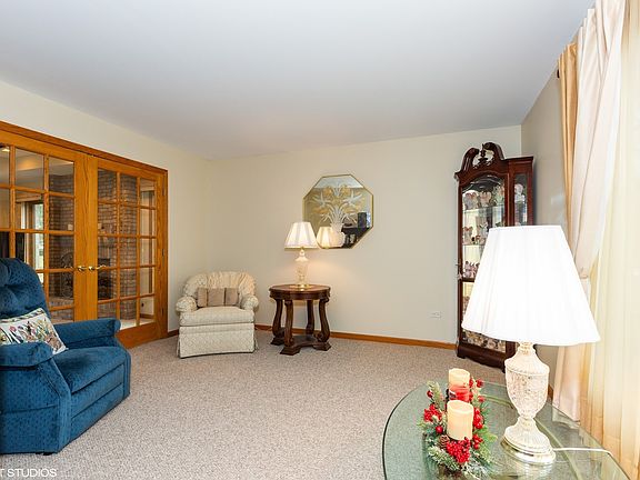 LIVING WITH FRENCH DOORS LEADING THE FAMILY ROOM