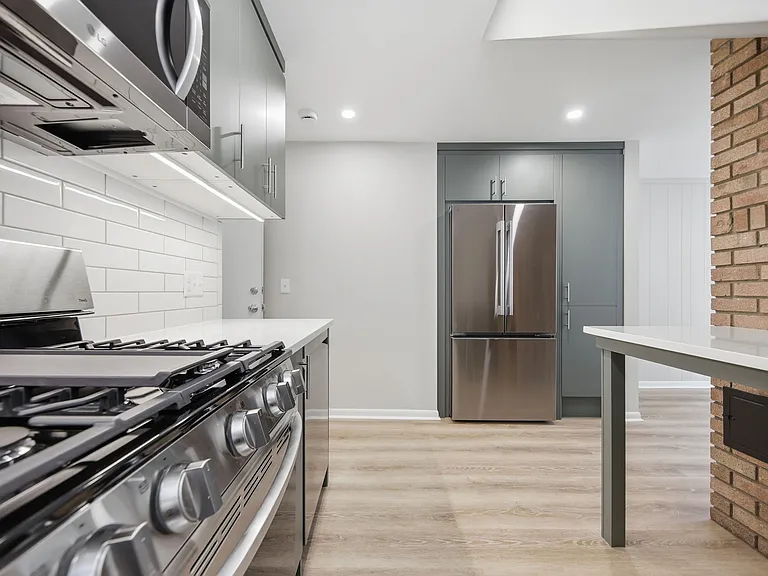 Large fridge with automatic ice maker, abundant built-in storage cabinets, under-cabinet lighting