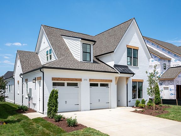 Front exterior with white siding and 2-car garage