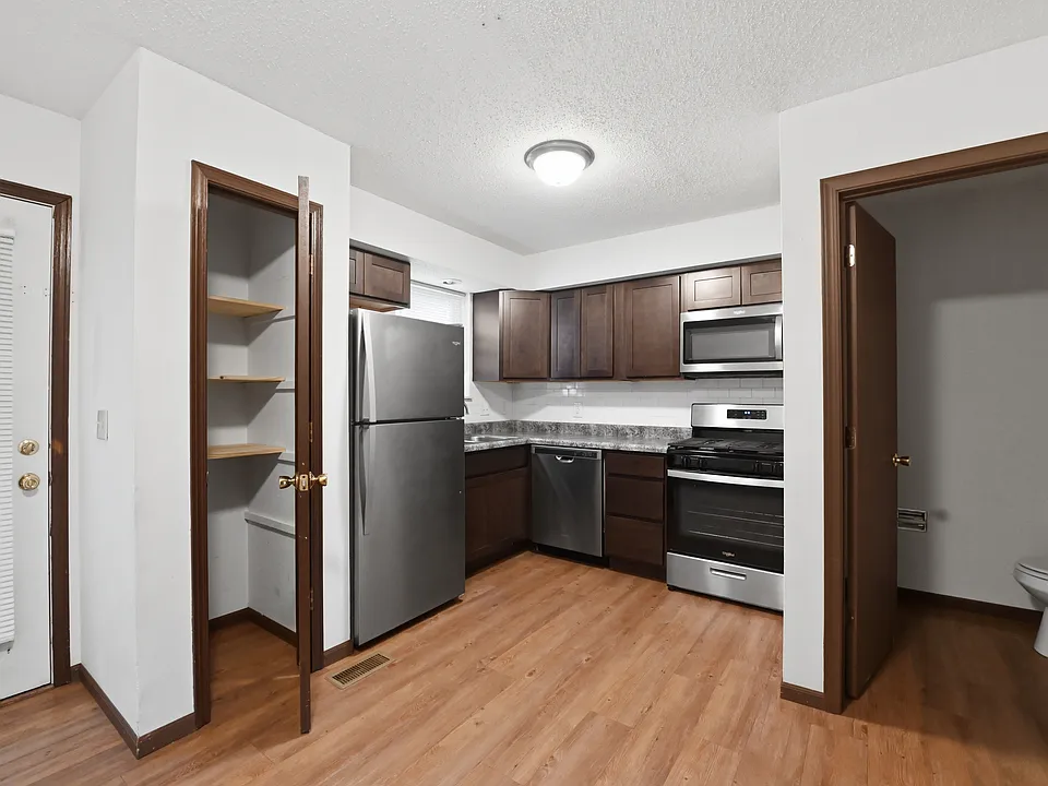 The Kirchen area with a pantry, stainless steel appliances, and the door to the rear patio. The main floor 1/2 bathroom is off the kitchen.