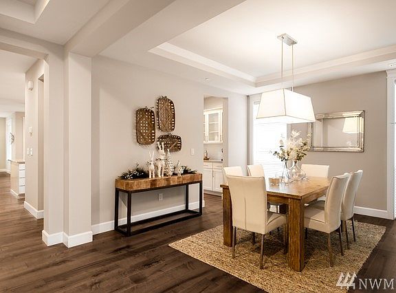 View of the formal dining room: finished with upgraded 6 in" hardwood floors, extends into the great room ( an included upgrade feature). When taking a tour of this plan, notice the many niches that captures your eye to the many layers, depth and dimension of every room...even in a hallway! Lot 1 is complete and Move-in Ready!