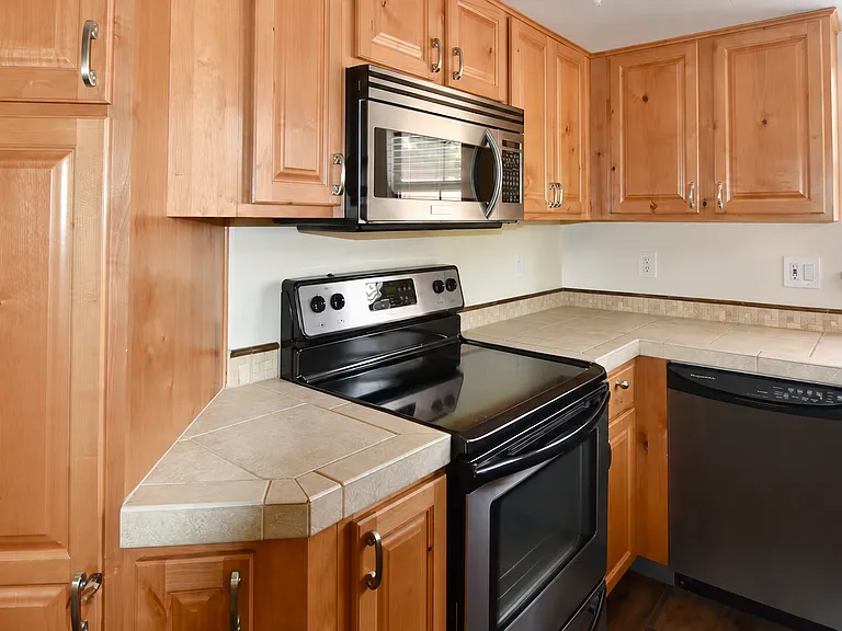 Kitchen has ample storage. Electric range, dishwasher, microwave and refrigerator are included
