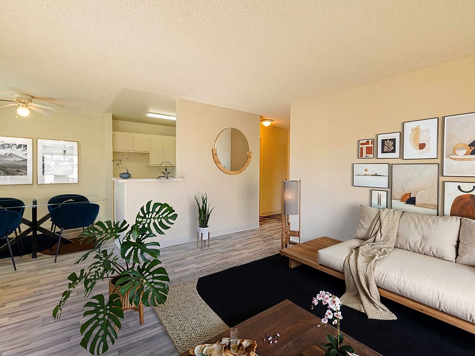 Contemporary living room with open flow to kitchen and dining.