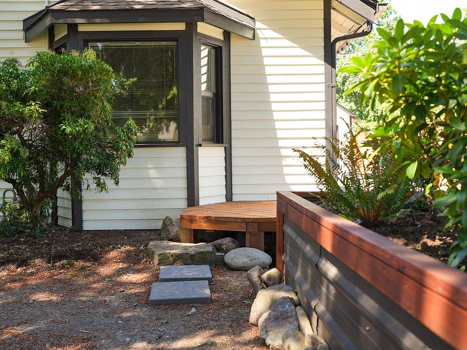 Entrance into the house. Up to three cars can park in the gravel driveway under the fir trees.