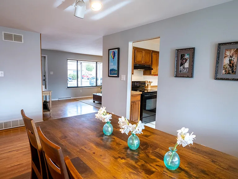 View from the north-west corner of the dining room, showing the entrance to the kitchen and and the west side of the living room.