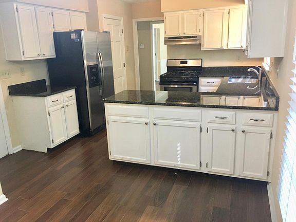 Kitchen has updated granite and stainless appliances. Kitchen opens to sunny breakfast room.