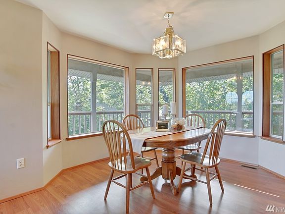 Formal Dining Room Overlooking Private Backyard & Wrap-Around Covered Deck.