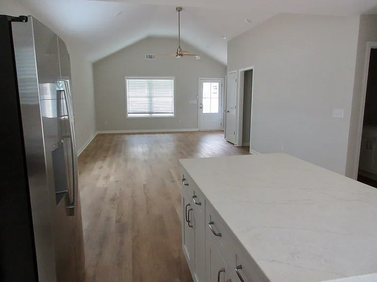 Standing in kitchen facing front door