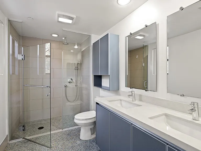 Bathroom with Walk-In Shower and Double Vanity with Cabinet Storage