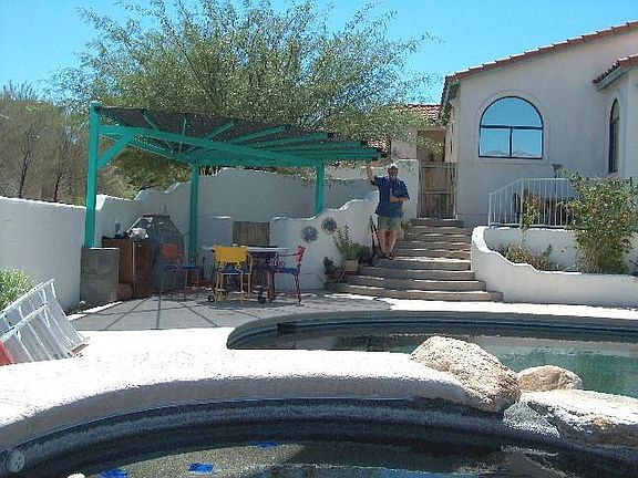 ramada and barbecue between pool and house