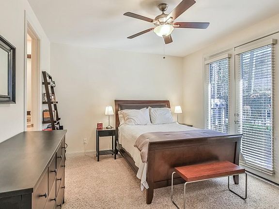 Spacious downstairs bedroom with en suite bath opens to patio.