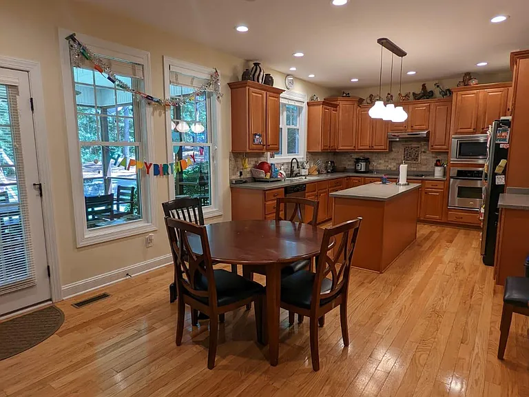 Large, well laid out kitchen with plenty of cabinetry and beautiful real hardwood floors.