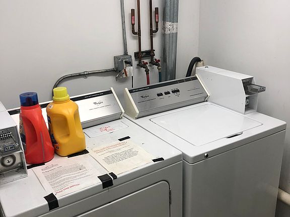 Shared washer and dryer, coin operated, for convenience.