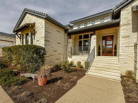 The contemporary craftsman appeal includes covered front porch and stacked limestone exterior.