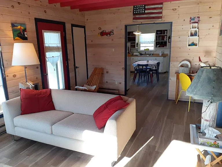 Home is furnished, including living room, TV, cable, small desk.