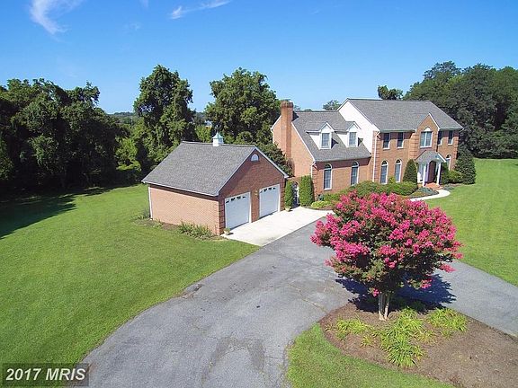Asphalt Drive Approaching Detached 2-Car Garage