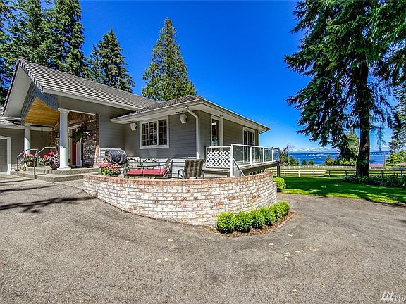 Beautiful covered front porch welcomes guests.