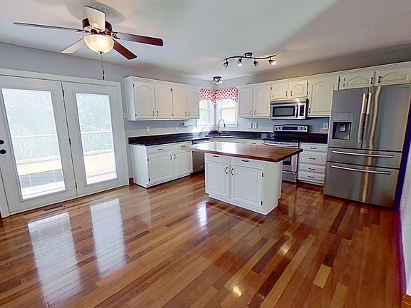 Updated kitchen with island and granite countertops.