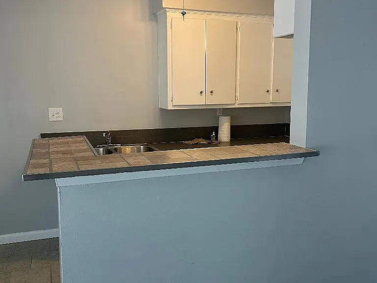 kitchen from living room
area, new paint and brand kitchen light