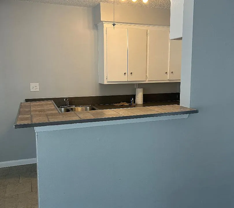 kitchen from living room 
area, new paint and brand kitchen light