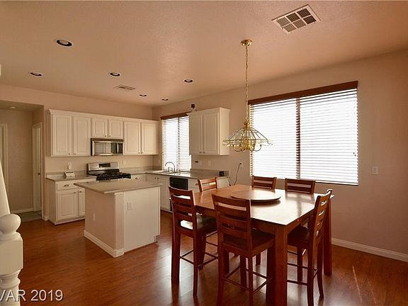 Dining area and Kitchen. Lots of windows to let the light in! (blinds throughout to keep it out!)