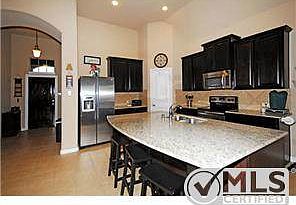 Open floor plan with kitchen overlooking dining and family room.