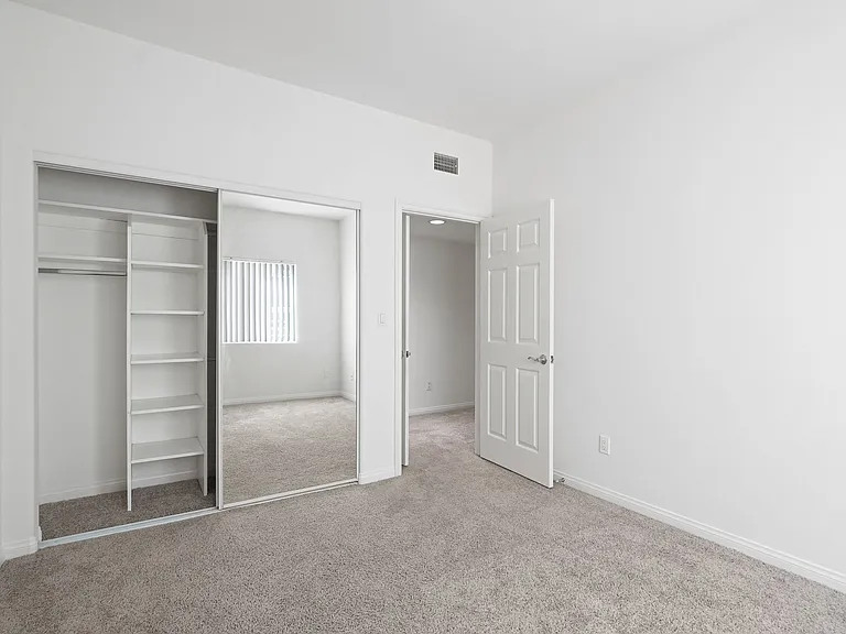 Bedroom with Closet with Built-In Shelving