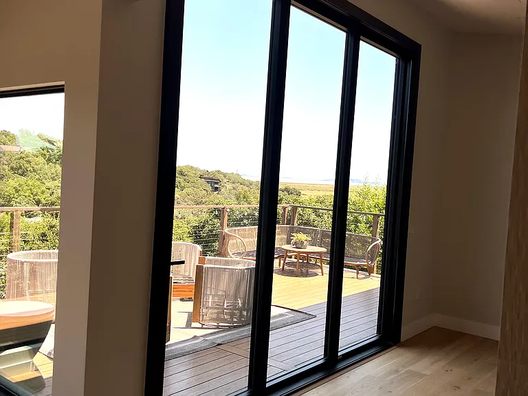 Adjacent great (lounge room) large window doors to front deck with view of Bay