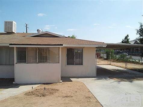 Front entry faces north toward Cajon; Evap Cooler and turbine vent on roof. Newer apartment complex can be seen across 7th St.