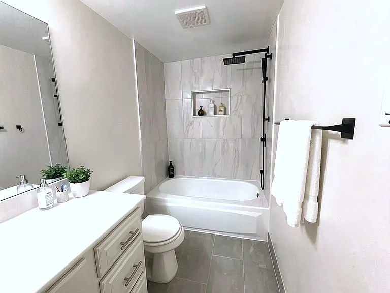 Digitally staged hallway bathroom.