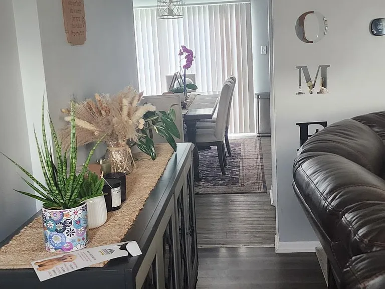 Open-concept dining area connects to the main living space, featuring a dedicated table setup and durable flooring.